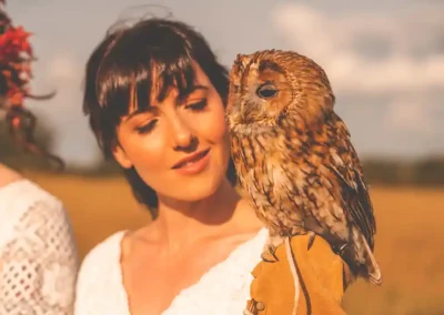 Fletcher the tawny owl (Strix aluca) poses on the brides shoulder for a photograph.